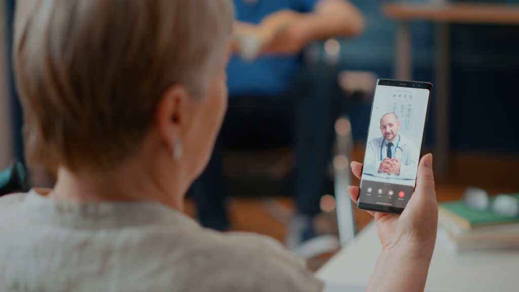 Retired woman attending online consultation on video-call  with medic, talking about health care. Senior adult using online videoconference with doctor for telemedicine and telehealth.